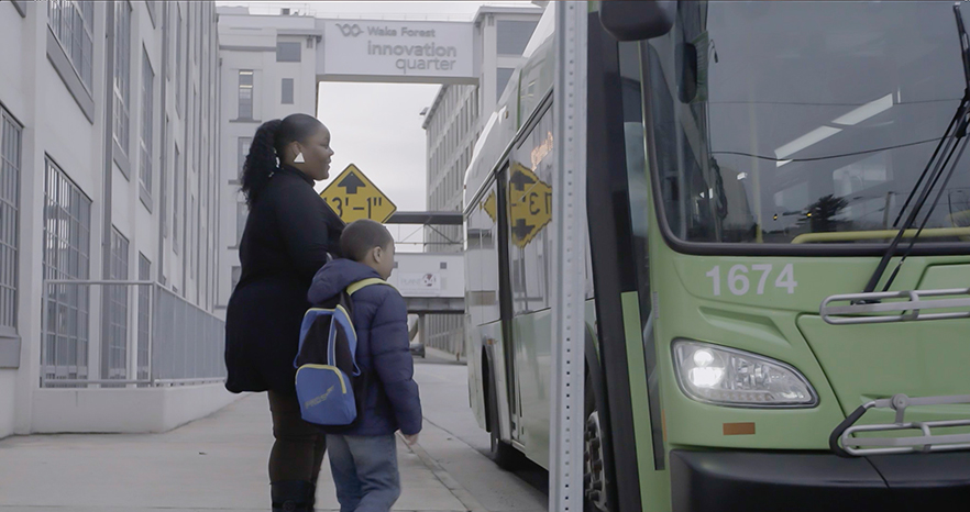 Brittany Marshall and son board a bus in downtown Winston-Salem