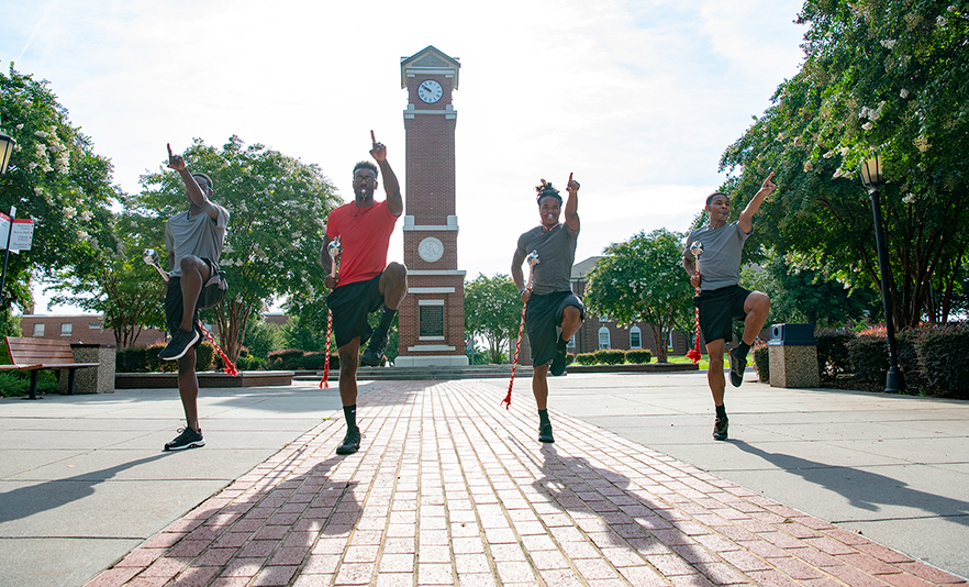 Red Sea of Sound Drum Majors perform near the WSSU clock tower