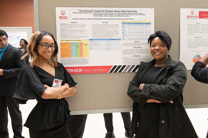 2 WSSU students stand by poster presentation during Scholarship Day