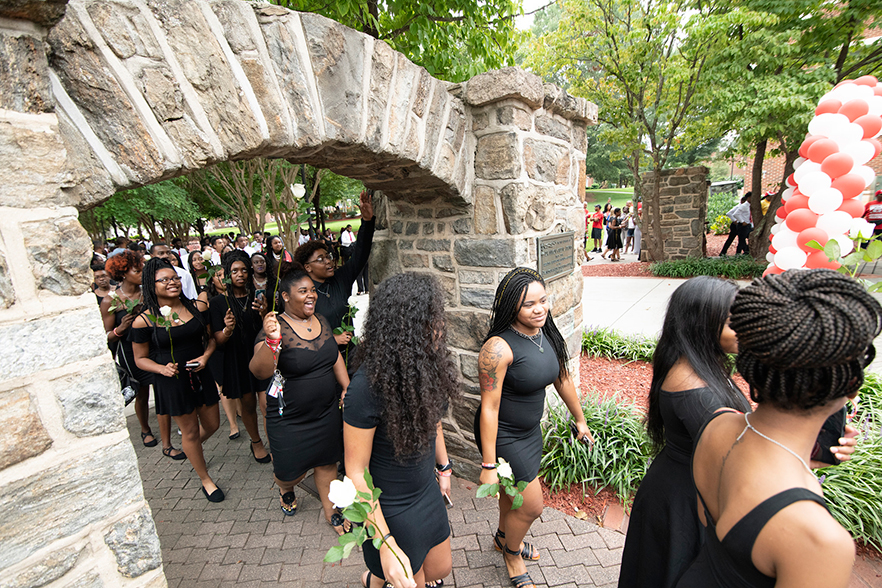 Students walk through the historic archways during Ramdition