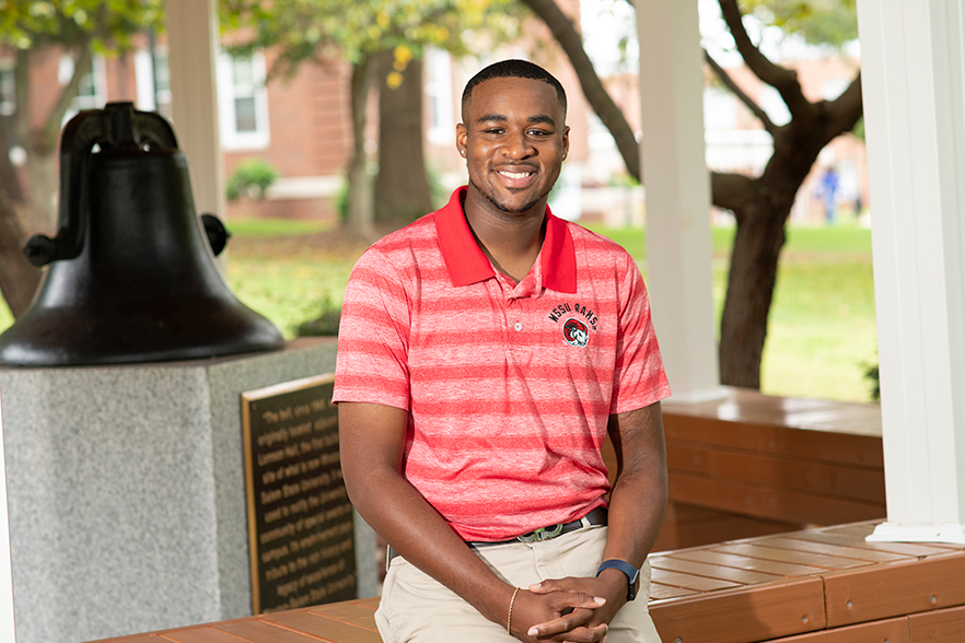 Island Green stands beside WSSU's historic bell on campus