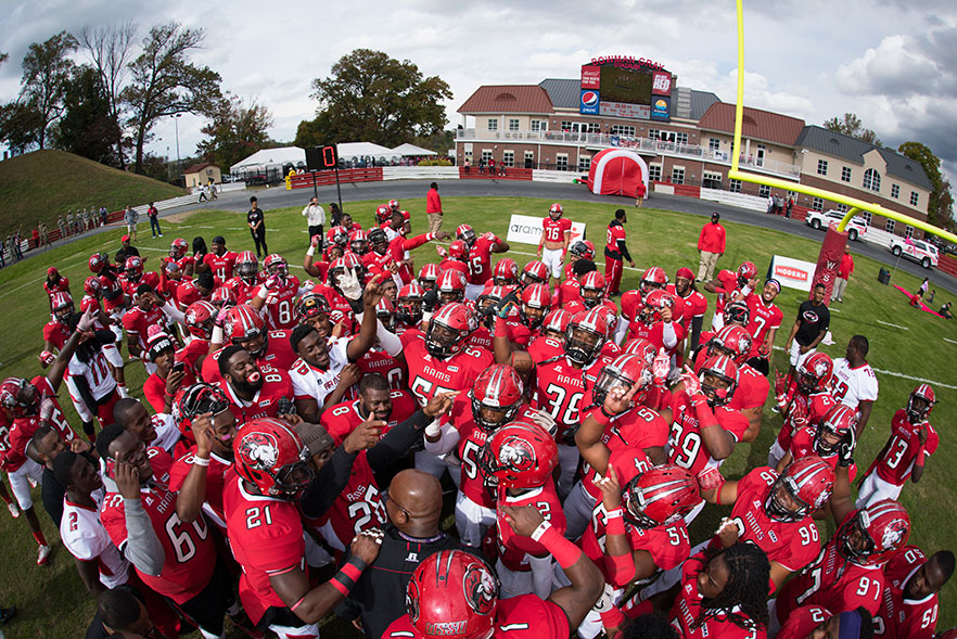 WSSU football team before the start of game - fieldhouse is in the background