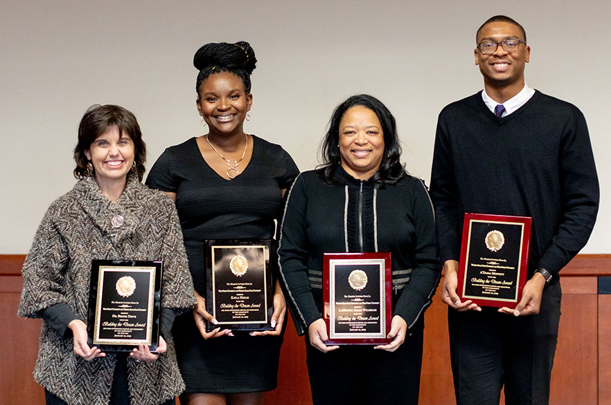 Award winners stand with award