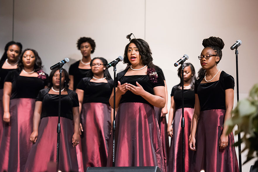 Singing Divas perform on stage at K.R. Williams Auditorium