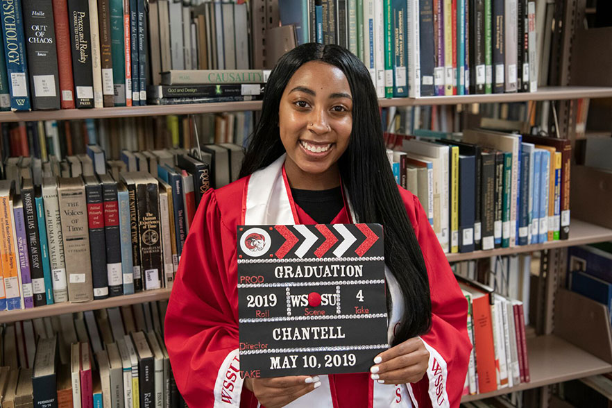 Chantell holds a director's clapboard that says: "Graduation - 2019 - WSSU - 4 - Chantell - May 10, 2019 