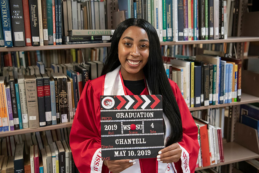 Chantell holds a director's clapboard that says: "Graduation - 2019 - WSSU - 4 - Chantell - May 10, 2019