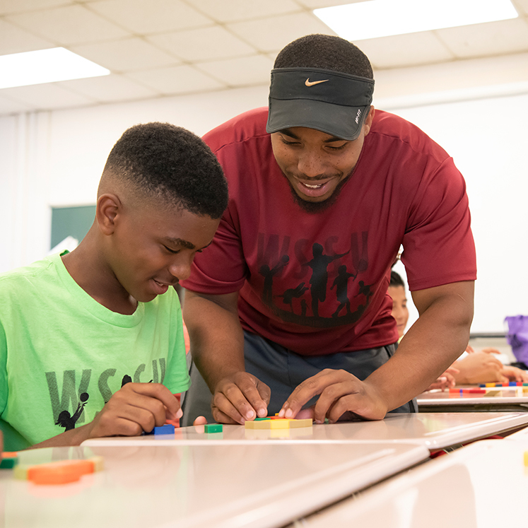 Black Male Teacher with student