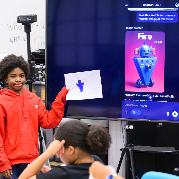 student holding drawing