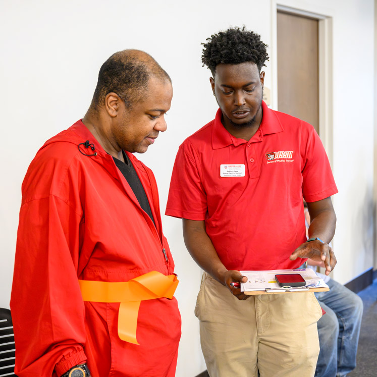 photo of student helping man