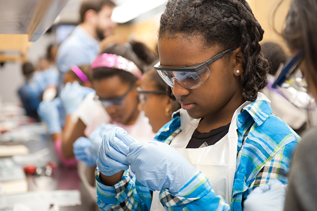 Camp youth glancing down with googles during STEM day.