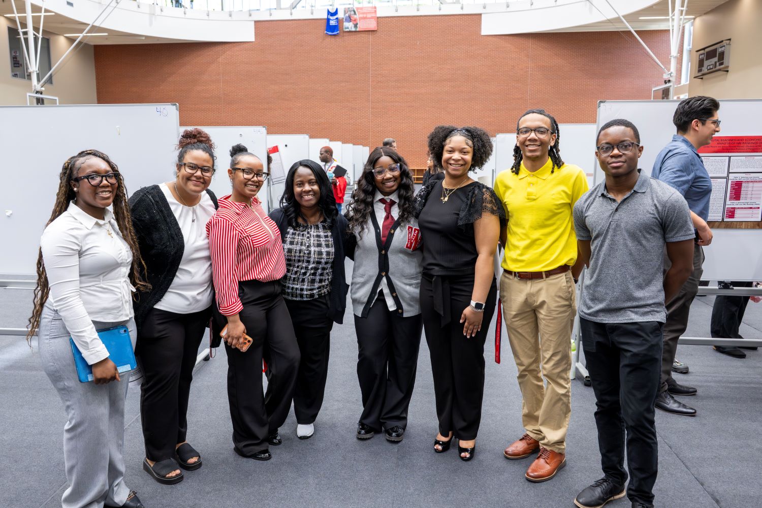 students with professor in group photo at Scholarship Day poster session