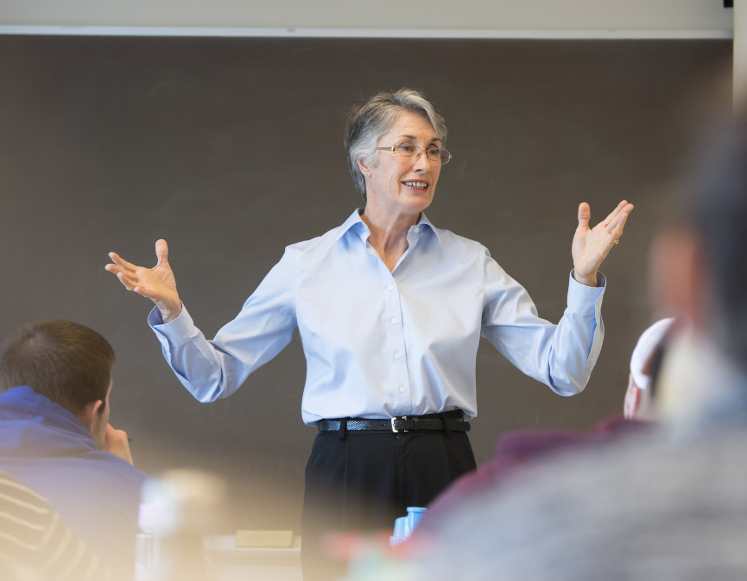 a lady speaking to a room of people