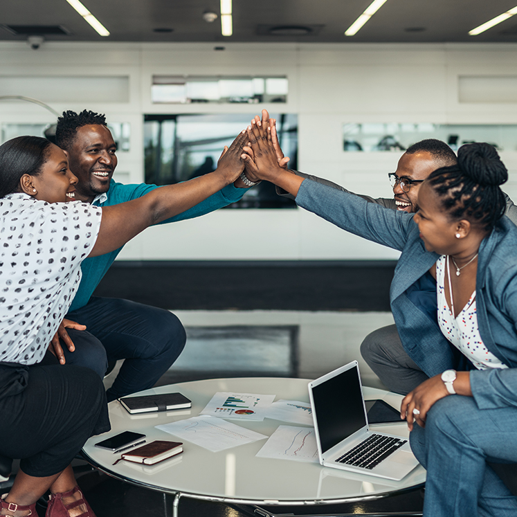 a group of employees high fiving