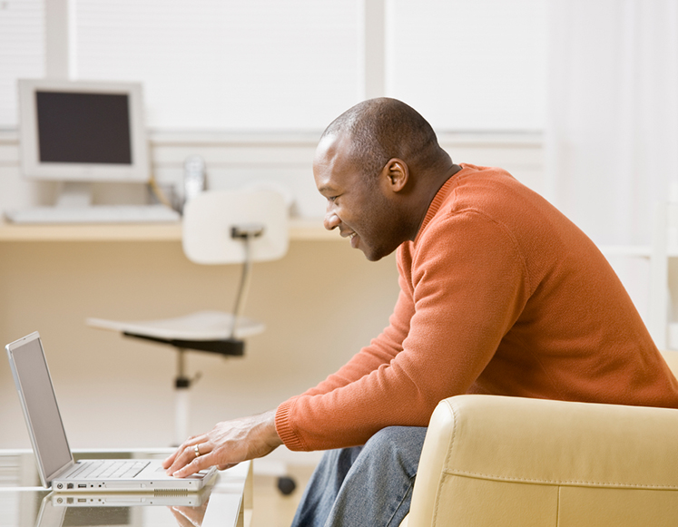 sitting man at laptop